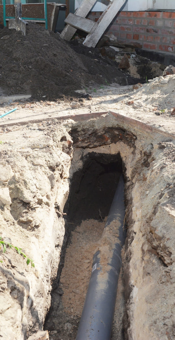 digging of a trench for a main drain pipe, sewer line replacement repair